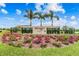 The Waterset Newland entrance sign is surrounded by grass, flowers, palm trees, and blue skies at 7209 Meeting House Ln, Apollo Beach, FL 33572