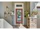 Inviting front door adorned with a wreath, decorative baskets, and stone column accents at 7209 Meeting House Ln, Apollo Beach, FL 33572
