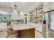 Gourmet kitchen with granite countertops, stainless appliances, island with seating, and open to the living area at 7209 Meeting House Ln, Apollo Beach, FL 33572