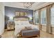 Main bedroom with a decorative light fixture, shuttered windows, and bedside tables at 7209 Meeting House Ln, Apollo Beach, FL 33572