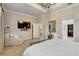 Spacious main bedroom with a cozy chair, decorative light fixture, and doorways to other areas at 7209 Meeting House Ln, Apollo Beach, FL 33572