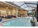 The outdoor pool area offers multiple seating arrangements and a bar, perfect for entertaining guests at 7209 Meeting House Ln, Apollo Beach, FL 33572