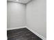 A versatile room showcases sleek, dark flooring and neutral walls, ready for personalization and various uses at 7209 Meeting House Ln, Apollo Beach, FL 33572