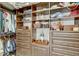 Spacious walk-in closet with custom shelving and drawers for optimal organization at 7209 Meeting House Ln, Apollo Beach, FL 33572