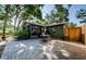 A stone paver patio, mature trees, the Florida room and privacy fence enhance the backyard at 7241 56Th N Ave, St Petersburg, FL 33709
