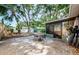 This backyard features a stone paver patio, shade trees, shed, and Florida room at 7241 56Th N Ave, St Petersburg, FL 33709