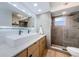 Modern bathroom boasts double sinks, a large mirror, and a walk-in shower at 7241 56Th N Ave, St Petersburg, FL 33709