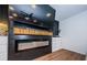 Contemporary fireplace featuring black wood paneling and a modern electric insert at 7241 56Th N Ave, St Petersburg, FL 33709