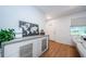 Bright entryway with wood floors, modern console table, and view to the front door at 7241 56Th N Ave, St Petersburg, FL 33709