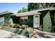 Close-up of home's front entrance featuring potted plants and manicured landscape at 7241 56Th N Ave, St Petersburg, FL 33709
