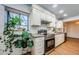 Bright kitchen featuring white cabinets, stainless steel appliances, and a large window at 7241 56Th N Ave, St Petersburg, FL 33709