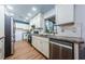 Bright kitchen featuring white cabinets, stainless steel appliances, and granite countertops at 7241 56Th N Ave, St Petersburg, FL 33709