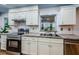 Updated kitchen with white cabinets, stainless steel appliances, and a double sink at 7241 56Th N Ave, St Petersburg, FL 33709