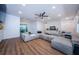 Bright and spacious living area with modern sectional, wood flooring, and sliding glass doors at 7241 56Th N Ave, St Petersburg, FL 33709