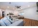 Open-concept living room with wood floors, a large sectional sofa, and ample natural light at 7241 56Th N Ave, St Petersburg, FL 33709