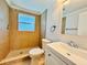 Bright bathroom with tiled shower, updated vanity, and framed mirror at 754 Seminole Blvd, Tarpon Springs, FL 34689