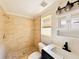 Tiled bathroom with glass door shower, modern vanity, and decorative lighting at 754 Seminole Blvd, Tarpon Springs, FL 34689