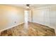 Light-filled bedroom featuring a ceiling fan, spacious closet, and wood-look flooring at 754 Seminole Blvd, Tarpon Springs, FL 34689