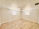 Bright bedroom with wood-look tile, ceiling fan, and natural light from windows at 754 Seminole Blvd, Tarpon Springs, FL 34689
