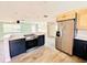 Modern kitchen featuring stainless steel appliances, blue cabinets, and quartz countertops at 754 Seminole Blvd, Tarpon Springs, FL 34689