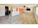 Bright living room featuring wood-look tile flooring, open layout, and ceiling fan at 754 Seminole Blvd, Tarpon Springs, FL 34689