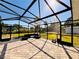 Spacious screened-in patio with brick pavers, comfortable seating, and a clear view of the well-maintained backyard at 754 Seminole Blvd, Tarpon Springs, FL 34689