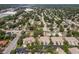 Wide aerial view of a residential neighborhood showcasing townhomes and tree-lined streets at 7826 66Th N Way, Pinellas Park, FL 33781