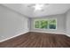Relaxing bedroom with ceiling fan, hardwood floors, and a bright window showcasing outdoor views at 7826 66Th N Way, Pinellas Park, FL 33781
