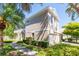 Side exterior elevation of a well-maintained two-story townhome with green landscaping at 7826 66Th N Way, Pinellas Park, FL 33781