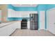Well-lit kitchen with white cabinets, stainless steel appliances, and bright blue walls at 7826 66Th N Way, Pinellas Park, FL 33781