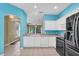 Well-lit kitchen with white cabinets, stainless steel appliances, and an open layout at 7826 66Th N Way, Pinellas Park, FL 33781