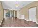 Spacious living room with hardwood floors, lots of natural light from sliding glass doors, and adjacent staircase at 7826 66Th N Way, Pinellas Park, FL 33781
