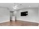 Open-concept living area with ceiling fan, media center, and hardwood floors, perfect for entertaining guests at 7826 66Th N Way, Pinellas Park, FL 33781