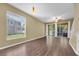 Bright living room featuring wood floors, a large window, and sliding glass doors that offer lots of natural light at 7826 66Th N Way, Pinellas Park, FL 33781