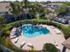 Community swimming pool with multiple lounge chairs and palm trees around the perimeter at 7826 66Th N Way, Pinellas Park, FL 33781