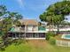 Home's exterior with a screened-in porch, balcony, and a well-maintained lawn at 8719 Lake Place Ln, Tampa, FL 33634