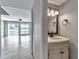 Stylish half bathroom with elegant vanity, lighting and tile flooring at 8719 Lake Place Ln, Tampa, FL 33634