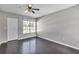 Neutral bedroom with a large window offering lots of natural light and hardwood floors at 8719 Lake Place Ln, Tampa, FL 33634