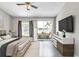 Comfortable bedroom with balcony access and scenic lake views at 8719 Lake Place Ln, Tampa, FL 33634