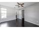 Spacious bedroom with hardwood floors, ceiling fan, and two large windows at 8719 Lake Place Ln, Tampa, FL 33634