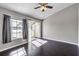 Well-lit bedroom features wood floors and outdoor balcony access at 8719 Lake Place Ln, Tampa, FL 33634