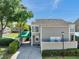 Townhome with a green awning, covered parking, and a well-maintained lawn at 8719 Lake Place Ln, Tampa, FL 33634