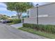 Exterior view of a townhome showing its covered parking and manicured landscaping at 8719 Lake Place Ln, Tampa, FL 33634