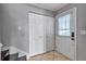 Welcoming foyer with closet, new door with window, and staircase access at 8719 Lake Place Ln, Tampa, FL 33634