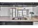 Kitchen features stainless steel sinks, granite countertops, and a seamless transition into a well-lit living space with lake views at 8719 Lake Place Ln, Tampa, FL 33634