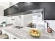 The kitchen is equipped with granite countertops, stainless steel sink, and a charming pass-through window to the dining area at 8719 Lake Place Ln, Tampa, FL 33634