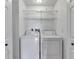 Convenient in-unit laundry area with shelving and a washer and dryer at 8719 Lake Place Ln, Tampa, FL 33634