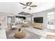 Open living room features a ceiling fan, natural light, and seamless access to the adjacent kitchen, perfect for entertaining at 8719 Lake Place Ln, Tampa, FL 33634