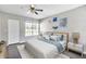 Bright main bedroom with ceiling fan, large window and modern decor at 8719 Lake Place Ln, Tampa, FL 33634