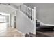 View of the staircase with its white railing and dark-stained wood treads in the house interior at 8719 Lake Place Ln, Tampa, FL 33634